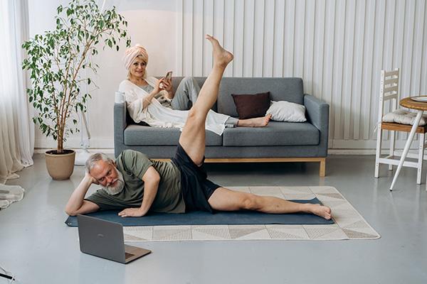 two people laying down, one is stretching