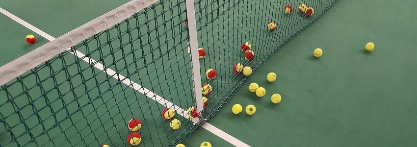 Photograph of tennis balls and a tennis net