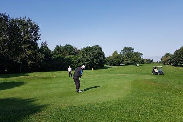 a person putting on the green of Sutton Park Golf Course