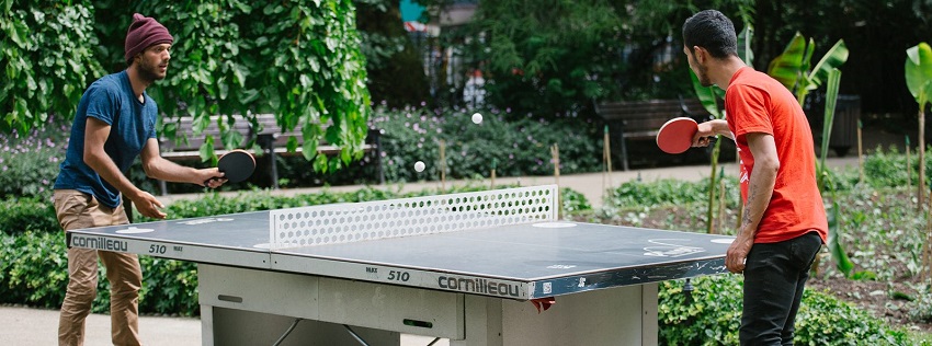 An image of two people playing on one of our outdoor table tennis tables