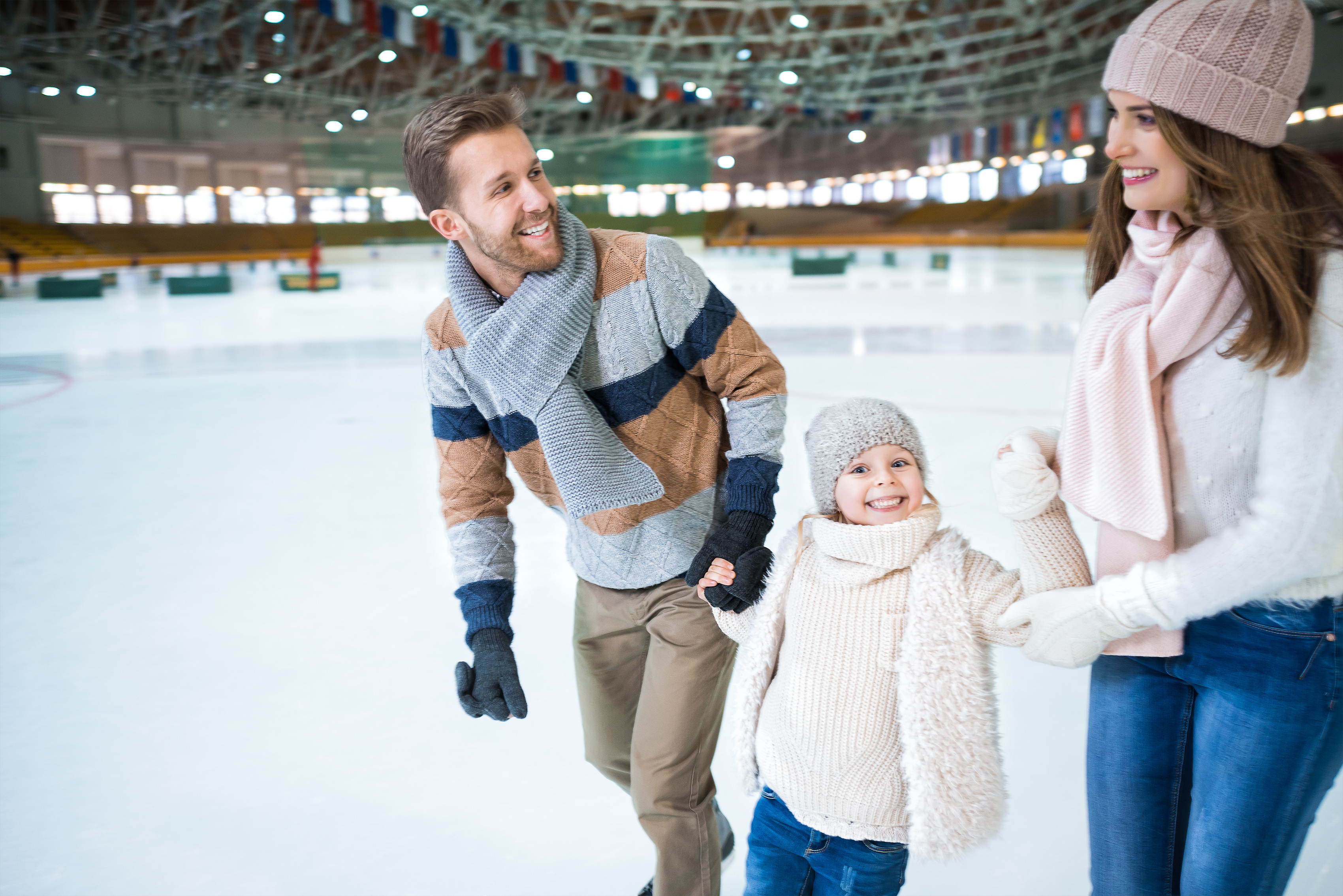 family skating on ice rink
