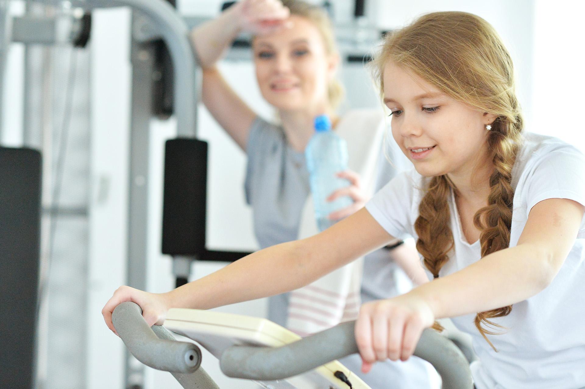Two people exercising in a gym